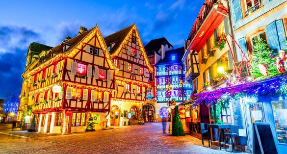 Photo of traditional Alsatian half-timbered houses Christmas decorated city in Alsace, Colmar, France.