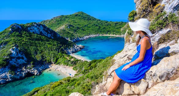 Photo of tourist with view of crystal clear azure water in Corfu.