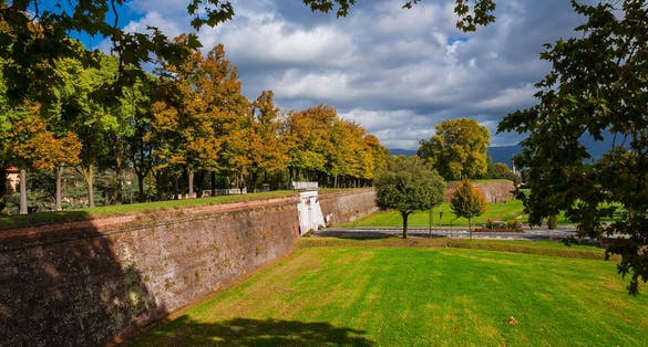 photo of view The Walls of Lucca public park. Porta Elisa (Elisa's Gate) with autumnal leave, Lucca, Italy.