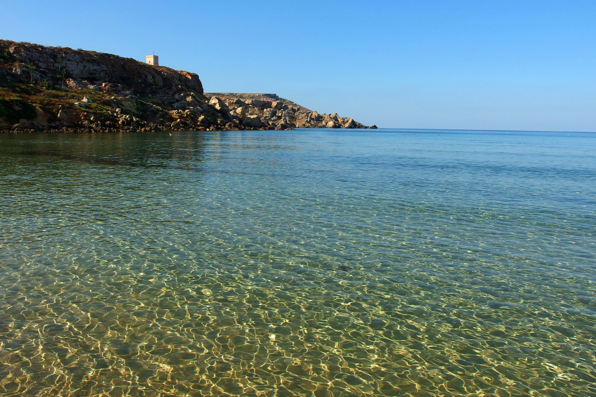 Photo of Golden bay beach on Malta island with calm transparent sea water.