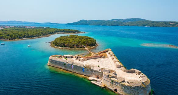 Photo of aerial view about St. Nicholas Fortress (Croatian: Tvrđava sv. Nikole) which is located at the entrance to St. Anthony Channel, near the town of Šibenik in central Dalmatia, Croatia.