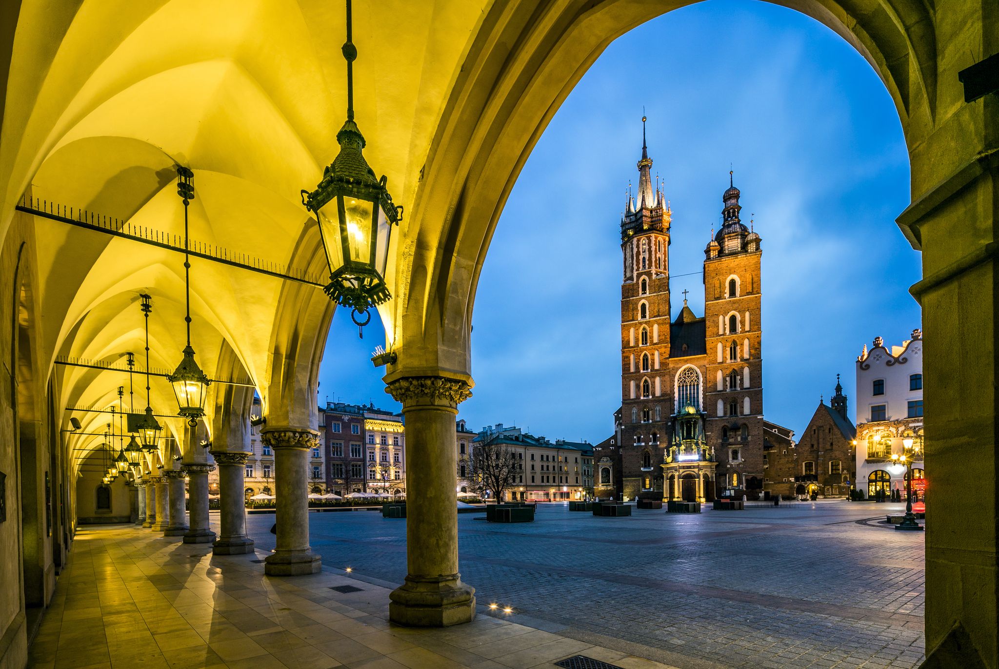 Photo of Illuminated Krakow market square at dawn, Poland.