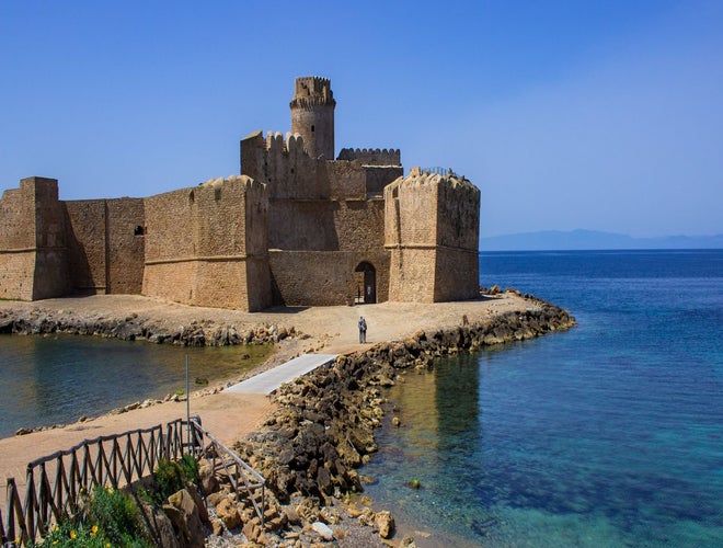 Scenic view of Le Castella fortress and clear coastal waters in southern Italy in June..jpg