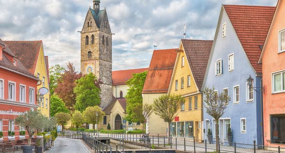 photo of colorful houses and bell tower of church of Our Lady in Memmingen, Bavaria, Germany.