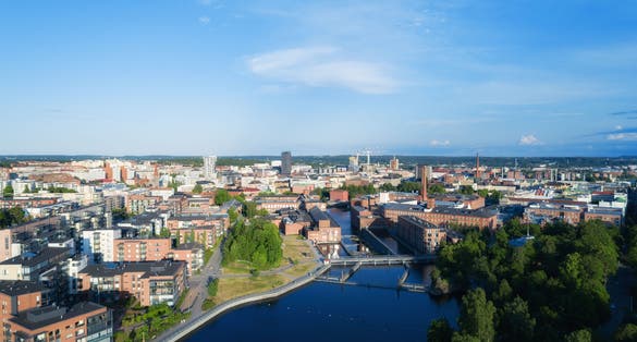 Aerial view of the Tampere city at sunset. Tampella building. View over Tammerkoski river in warm sunlight.