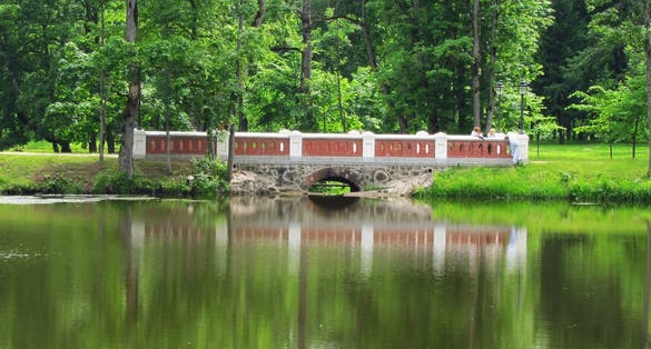 photo of plunge park of lietuva park with water. Beautiful trees and pond, there are a lot of stones. Near forest, you can walk in this great place for family.