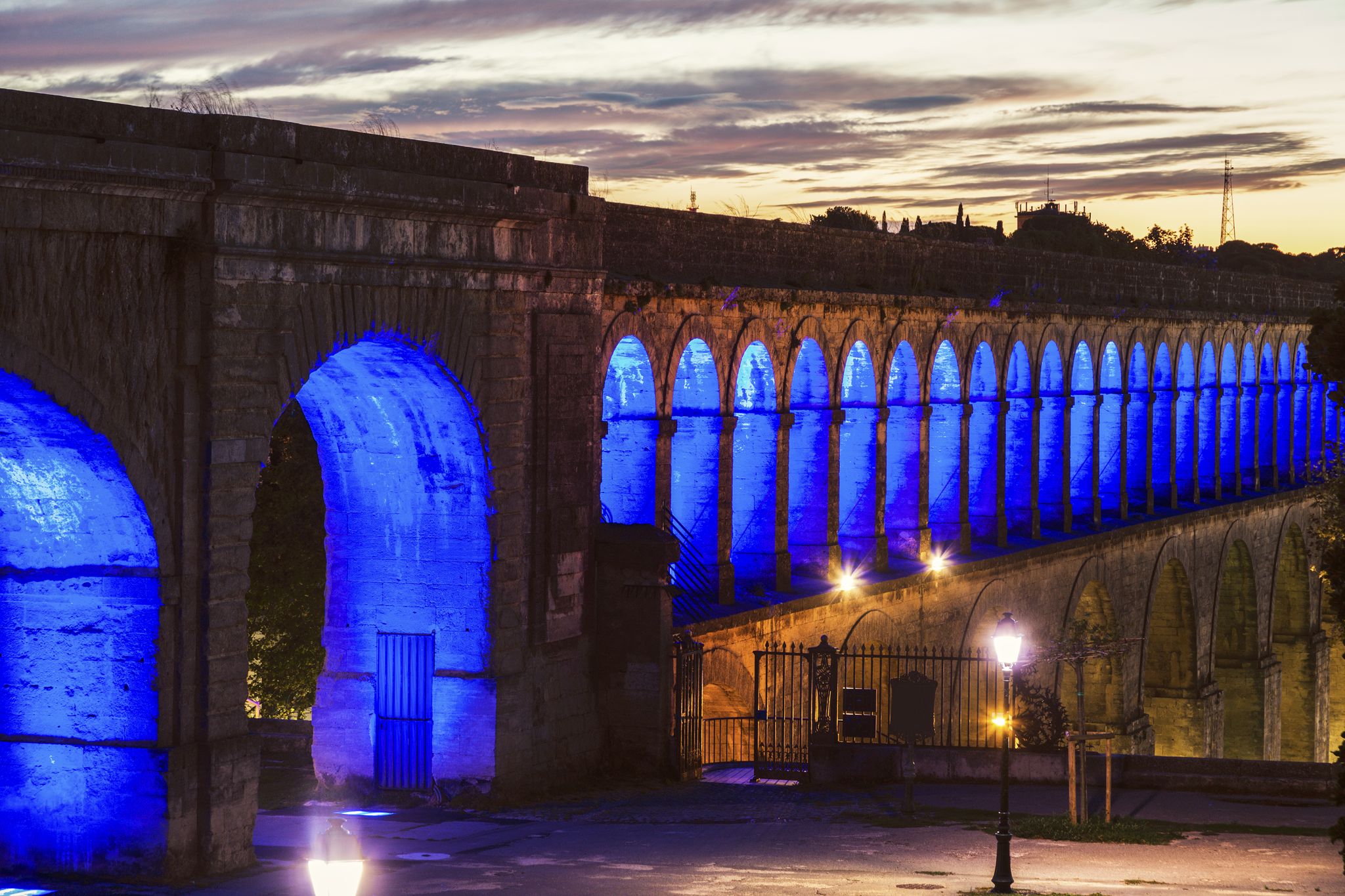 photo of Saint Clement Aqueduct at night in Montpellier, France.