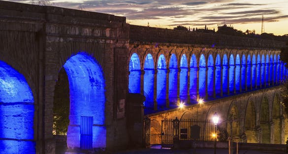 photo of Saint Clement Aqueduct at night in Montpellier, France.