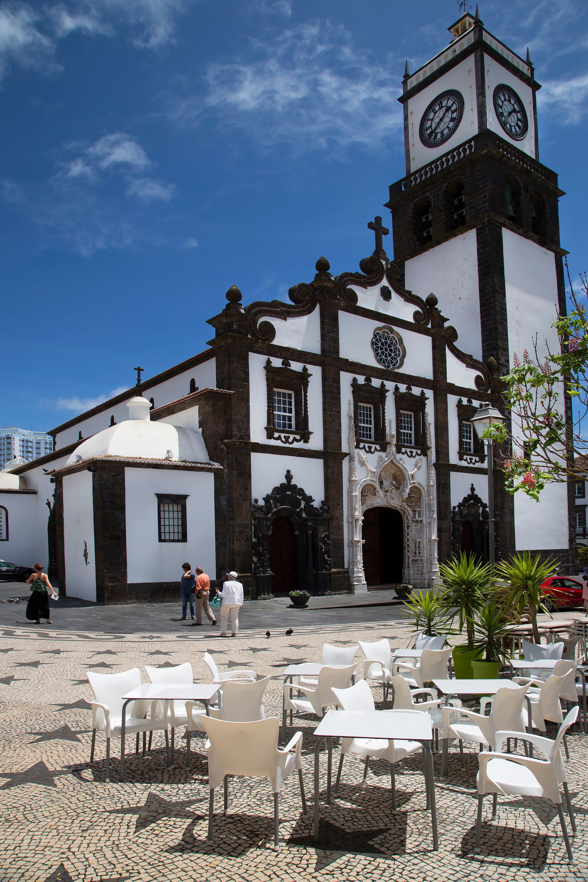Ponta Delgada city center church with decorative pavement design pattern and street furniture.