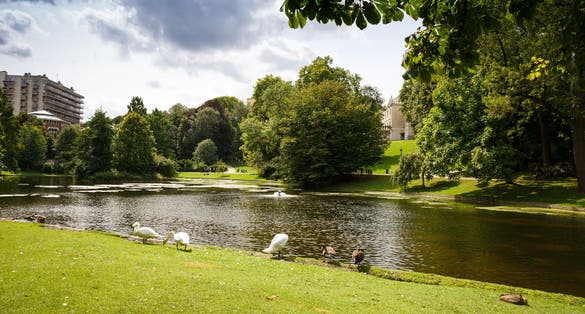 photo of view of Leopold park with pond, birds and people in Brussels, Belgium.