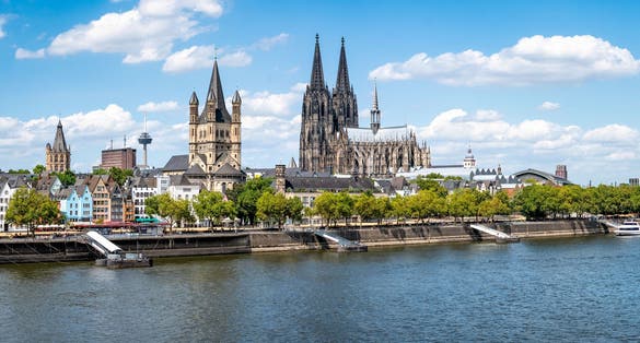 Photo of Cologne city skyline in summer along the Rhine river, North Rhine-Westphalia, Germany.