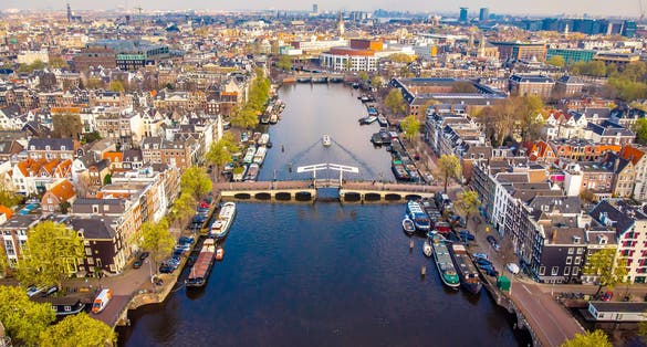 photo of Amsterdam city canal aerial view of Magere Brug or Skinny Bridge in the Netherlands.