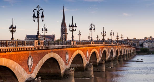 Photo of Pont de pierre at sunset in the famous winery region Bordeaux, France.