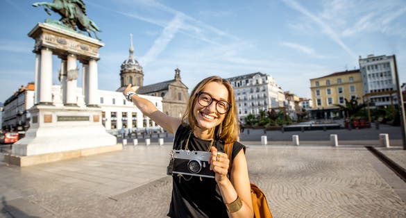 photo of portrait of a young woman tourist on the Place de Jaude in Clermont-Ferrand, France.