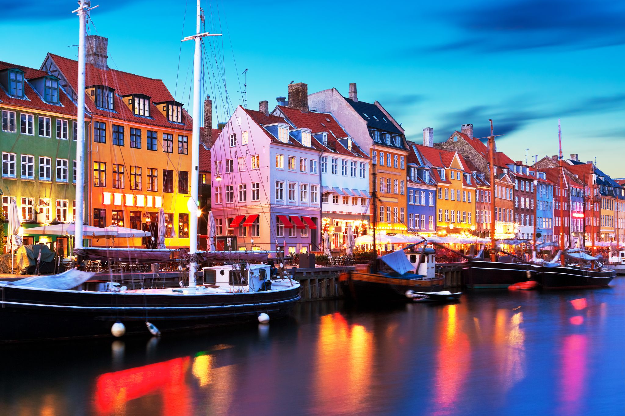 Photo of scenic evening panorama of famous Nyhavn pier architecture in the Old Town of Copenhagen, Denmark.