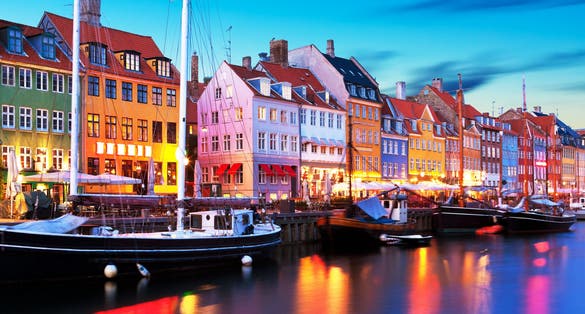 Photo of scenic evening panorama of famous Nyhavn pier architecture in the Old Town of Copenhagen, Denmark.