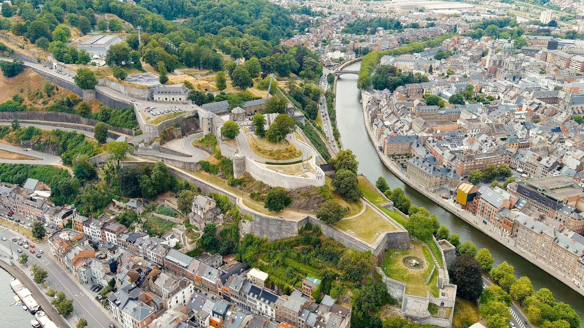 photo  of view of Namur, Belgium. Citadelle de Namur - 10th-century fortress with a park, rebuilt several times. Panorama of the central part of the city. River Meuse. Summer day, Aerial View