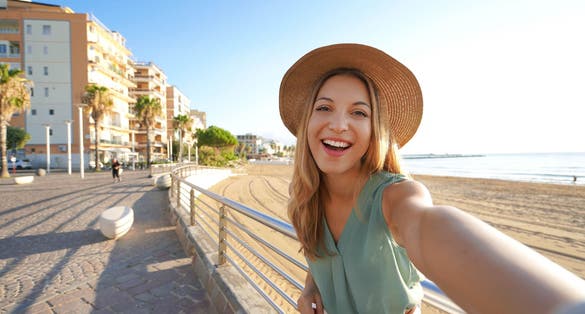 photo of  view of Holidays in Calabria. Selfie girl on Crotone promenade in Calabria, southern Italy.