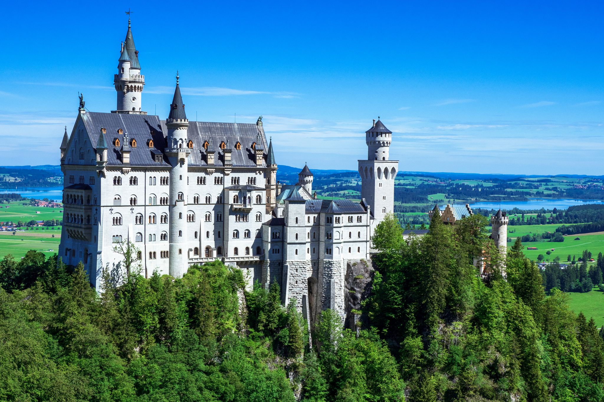 photo  of view of View of famous and amazing Neuschwanstein Castle, Füssen, Bavaria, Germany, seen from the Marienbrücke (Mary's Bridge), a pedestrian bridge built over a cliff