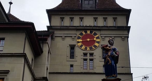 photo of medieval tower Käfigturm with Anna Seiler Fountain in Bern, Switzerland.