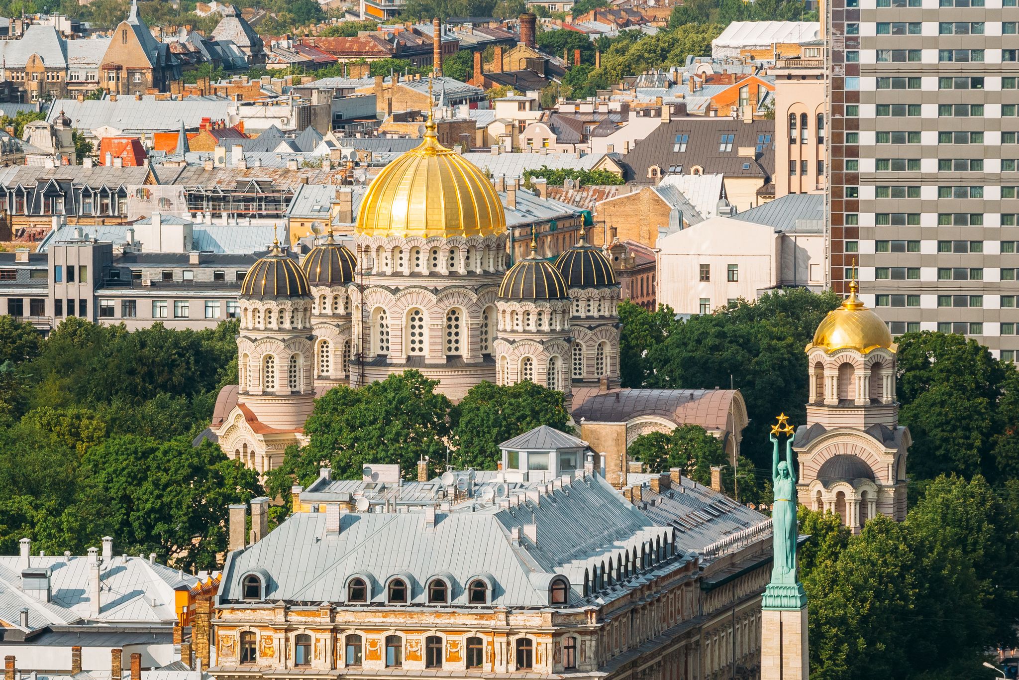 photo of Riga, Latvia. Riga cityscape in sunny summer day. Top view of famous landmarks - Riga nativity of christ cathedral and memorial freedom monument.