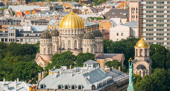 photo of Riga, Latvia. Riga cityscape in sunny summer day. Top view of famous landmarks - Riga nativity of christ cathedral and memorial freedom monument.