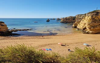 Photo of aerial view of touristic Portimao with wide sandy Rocha beach, Algarve, Portugal.