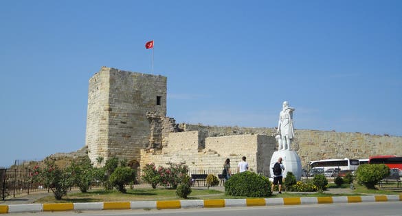 photo of Statue of Diogenes, famous ancient Greek philosopher born in Sinop in the 5th century BC. Sinop fortress in background in Turkey.