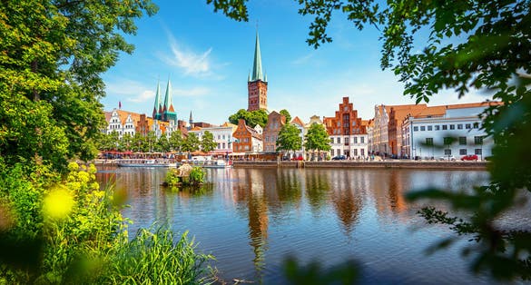 photo of  view  of Classic panoramic view of historic skyline of hanseatic town of Lübeck with famous St. Mary's Church on a beautiful sunny day with blue sky in summer, Schleswig-Holstein, Germany