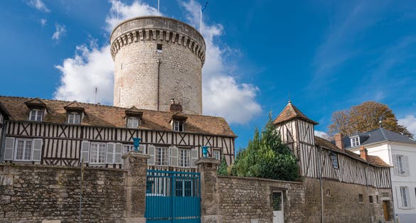 Photo of Old timber-framed houses and the ruin of the medieval fortification in the village Vernon, Upper Normandy, France.