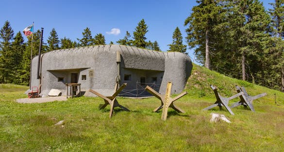 RICKY V ORLICKYCH HORACH, CZECH REPUBLIC (CZECHIA) – JULY 6, 2024: Infantry blockhouse R-S 89 "Prusek" with Czech hedgehogs on a sunny day, Hradec Kralove Region (Královéhradecký kraj)