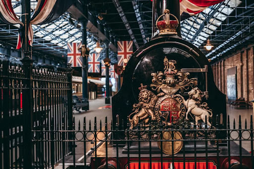 A historic royal train engine with ornate details is displayed at the National Railway Museum..png