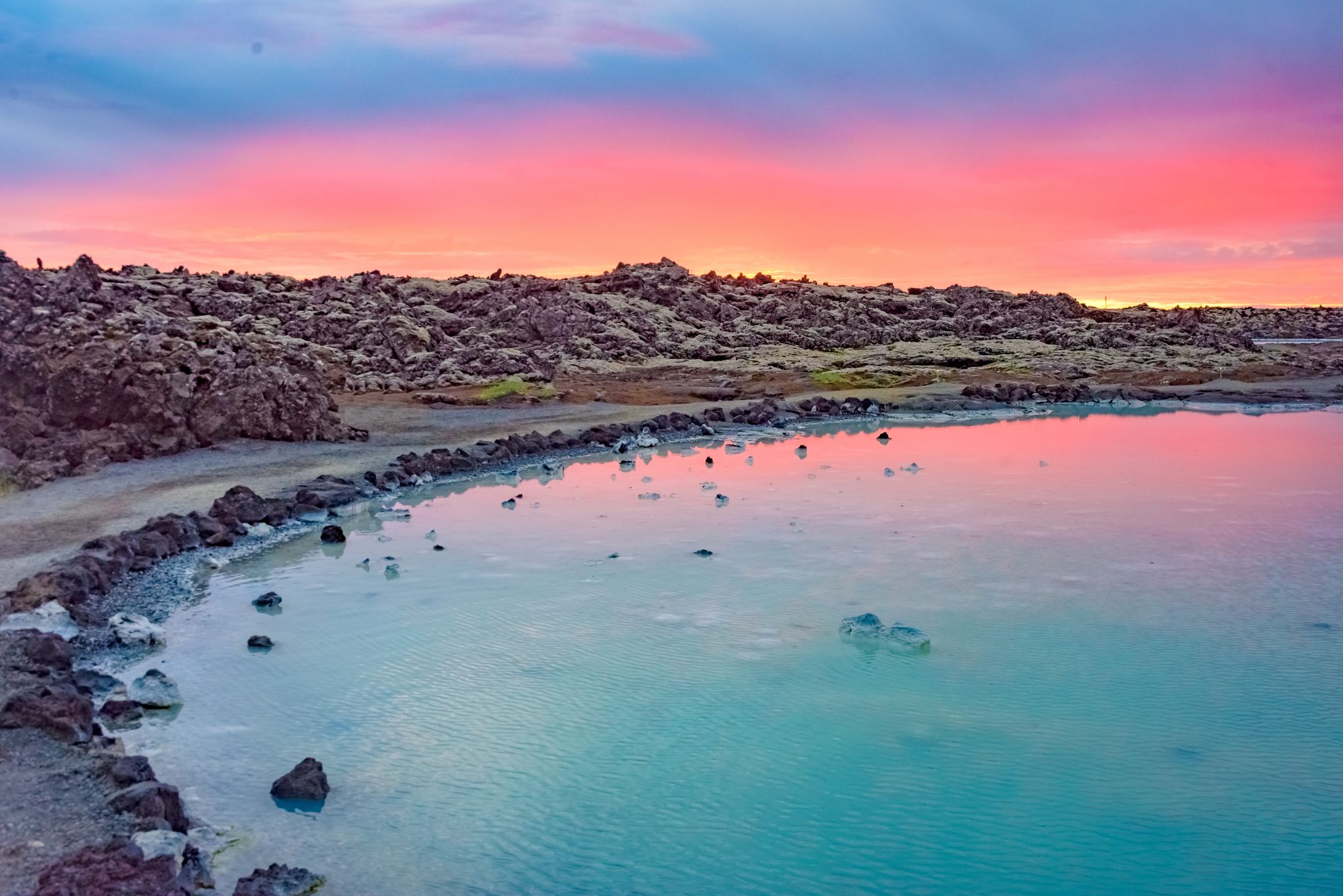photo of view of Midnight sun over the Blue Lagoon geothermal spa, near Grindavik, Reykjanes peninsula, Iceland/