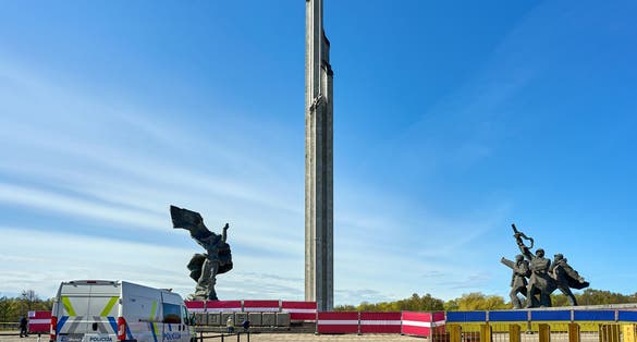 photo of Riga, Latvia - May 8, 2022: Victory park (Uzvars parks) decorated with Latvian and Ukrainian flags. The police are on duty.