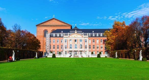 Photo of TRIER, GERMANY - NOVEMBER 05, 2015: electoral palace with unidentified people. It is a renaissance and rococo building from 17th century, where formerly the archbishop-electorals of Trier resided.