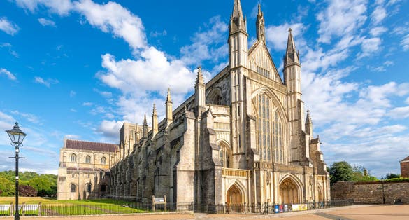 Photo of the medieval Cathedral Church of the Holy Trinity, Saint Peter, Saint Paul and Saint Swithun, commonly known as Winchester Cathedral, in the city of Winchester, England.