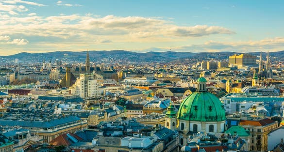 photo of Aerial view of Vienna with tower of the town hall building, votivkirche and peterskirche churches from the stephansdom cathedral, Vienna, Austria.