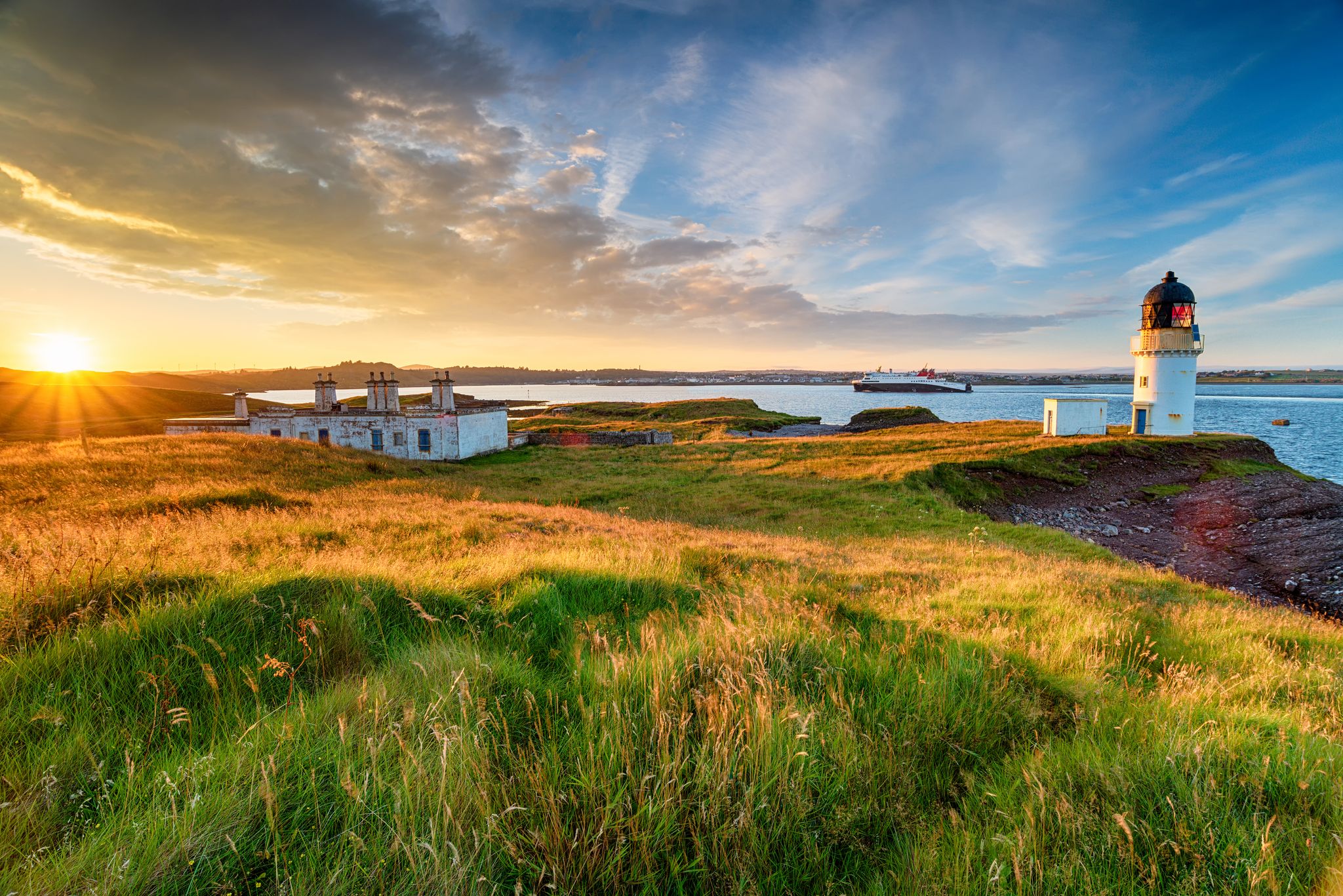 photo of stunning sunset over Arnish Point and it's lighthouse overlooking Stornoway harbor on the Isle of Lewis in the Outer Hebrides of Scotland.