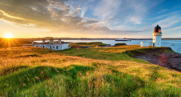 photo of stunning sunset over Arnish Point and it's lighthouse overlooking Stornoway harbor on the Isle of Lewis in the Outer Hebrides of Scotland.