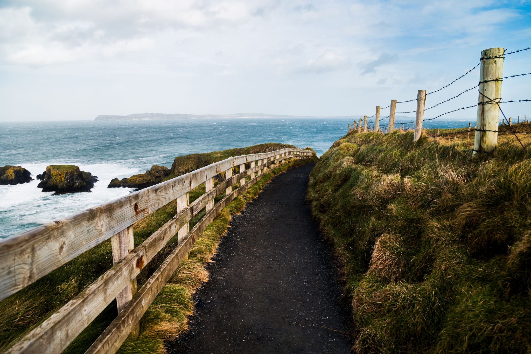 Point of view of a stunning trekking path in Giant's Causeway, Northern Ireland. An ideal destination for hiking and exploring a geological wonder. A UNESCO World Heritage Site.