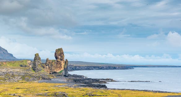 photo of view of Lóndrangar basalt pinnacles, on the southern coast of the Snæfellsnes Peninsula, Iceland.