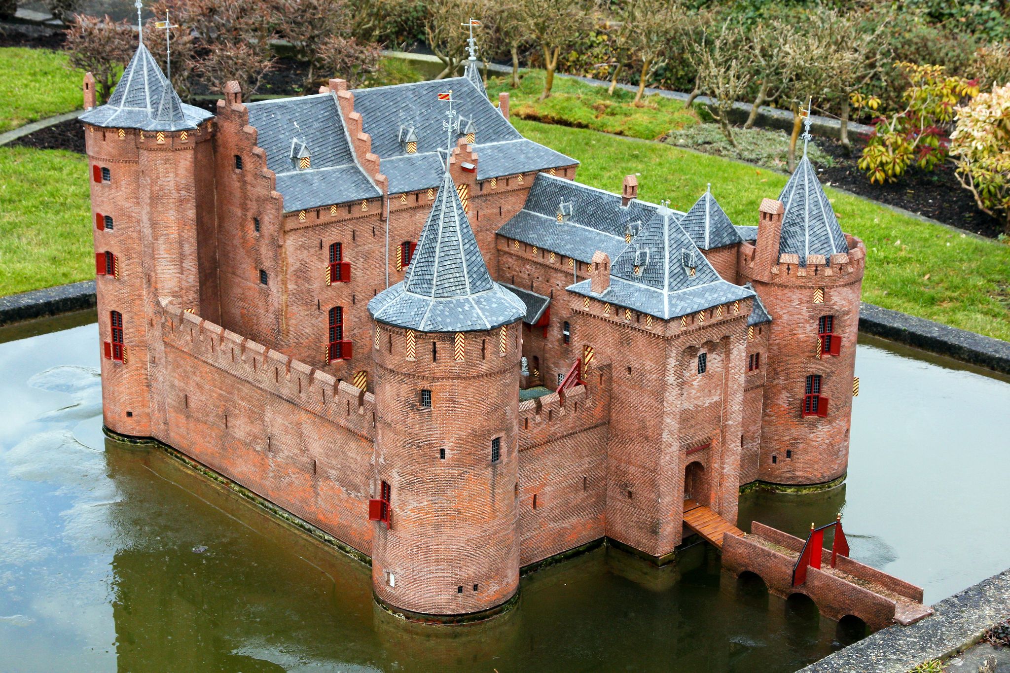 Photo of Madurodam red ancient castle miniature in water, Netherlands.
