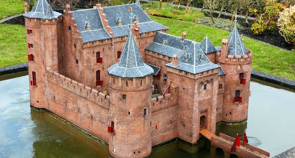 Photo of Madurodam red ancient castle miniature in water, Netherlands.