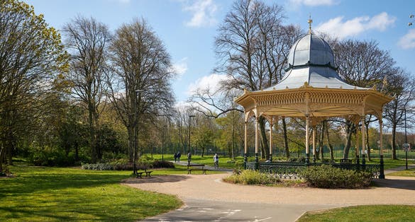 Photo of Bandstand in Exhibition Park on a summer day with a blue sky and green grass park, UK.