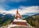 photo of stunning view of the top of Harder Kulm in Interlaken in winter, Switzerland photographed in summer with paragliders flying around. Hilly Alpine landscape and Lake Thun in background.