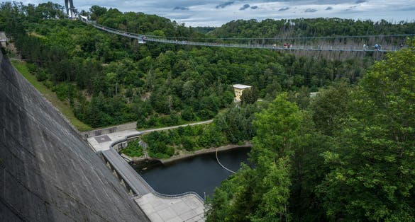 photo of view of The 458 meters long suspension bridge Titan-RT at Rappbode Dam, Neuwerk, Germany.
