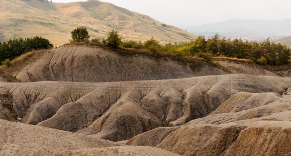 The surrounding landscape formed by the dried off volcanic mud - a geological reservation located in Scorțoasa commune, Buzău County in Romania.