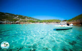 Photo of aerial view of Pythagorio port with colourful houses and blue sea, Samos island, Greece.