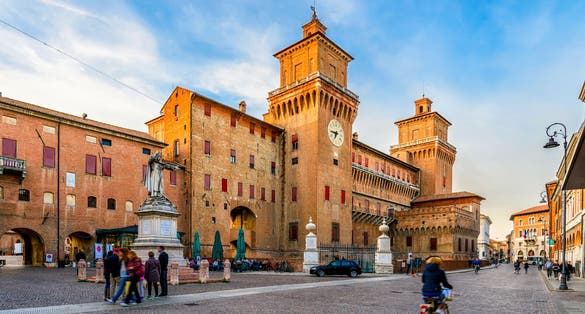 photo of Castle Estense (Castello Estense) and piazza Savonarola and monumet to Savonarola in Ferrara, Emilia-Romagna, Italy. Ferrara is capital of the Province of Ferrara