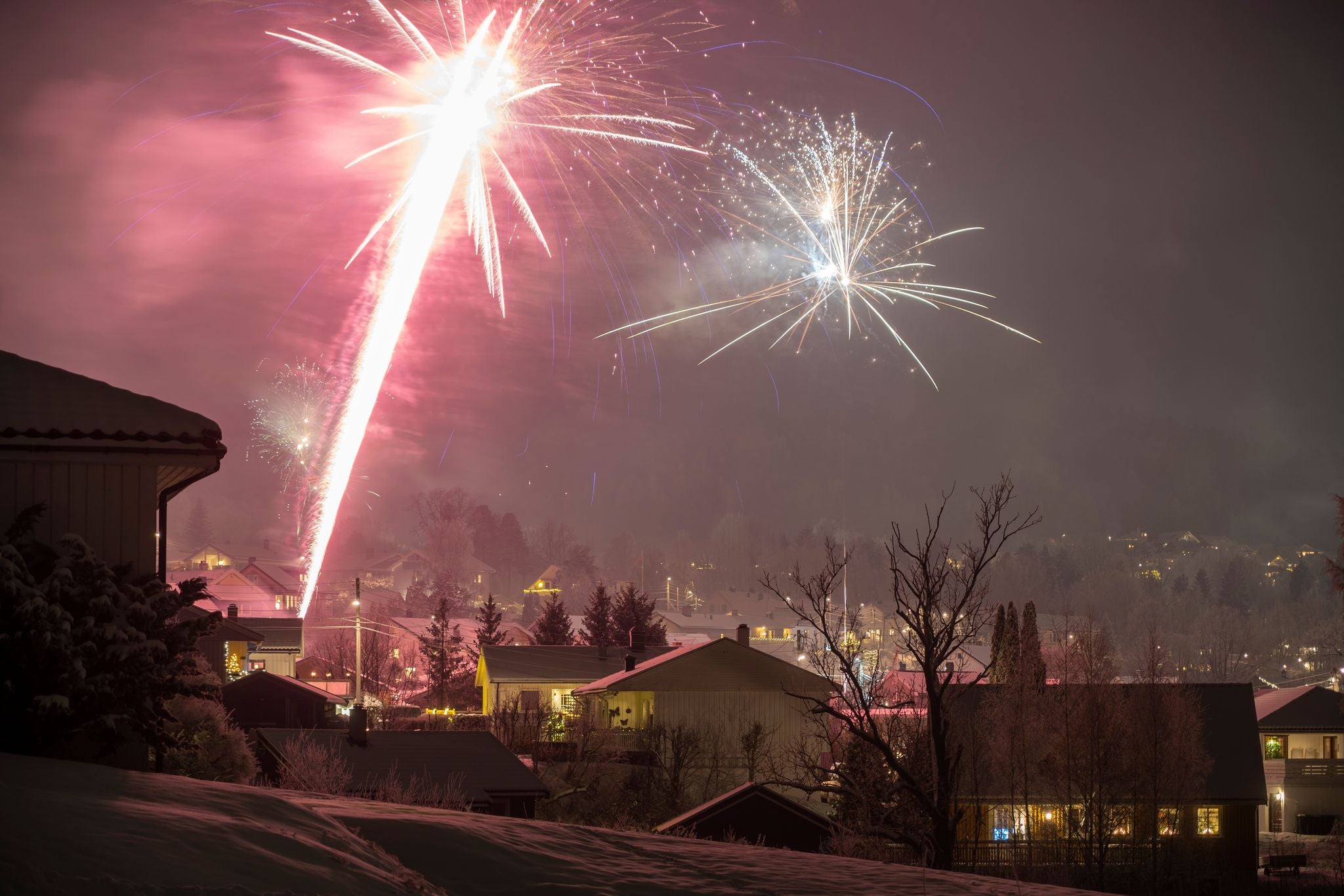 Exuberant Explosions Paint the Sky, Marking a Joyous Scandinavian Celebration Over Drammen, Norway.
